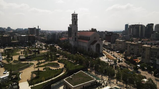 Aerial: Cathedral Of Saint Mother Teresa In City Against Sky, Drone Flying Forward On Sunny Day - Pristina, Kosovo