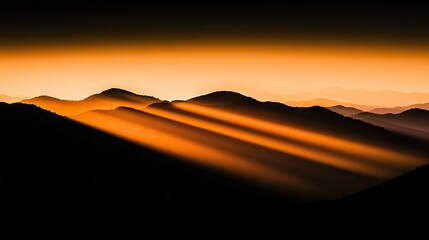 Dramatic sunlight streams illuminating layers of dark mountains and landscape