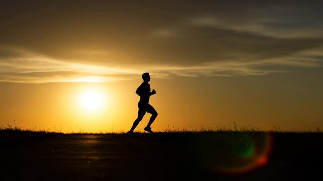 Runner jogging during sunset against a dramatic sky