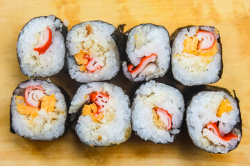 some pieces of sushi on a wooden background