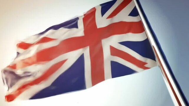 Waving national flag of the united kingdom flapping on a flagpole against a clear blue sky. Symbol of patriotism, identity, and national unity, suitable for various concepts. footage.
