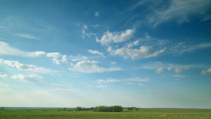 A Serene Sky Spanning Over Lush Green Fields, Casting a Bright and Calming Atmosphere