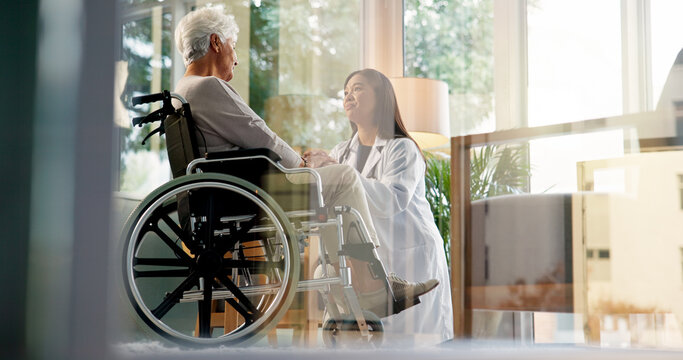 Women, caregiver and senior patient in wheelchair at retirement home for healthcare, support and checkup. Doctor, person with a disability and empathy for medical service, physiotherapy and care