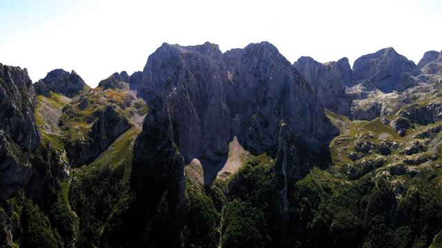 Aerial Tilt Up Scenic Shot Of Dramatic Hiking Mountains Against Clear Sky - Plav, Montenegro