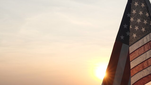 Memorial Day USA. Remember and Honor. Silhouettes of American flag waving on background of beautiful sunset or sunrise for honoring, mourning USA military. Memorial Day, Happy Holiday American Concept