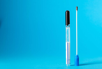 Smear for flora and bacterial culture in men and women on a blue background in urology and gynecology. Sexually transmitted infections. Copy space for text