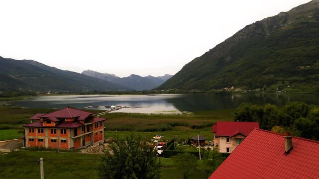 Aerial Forward Shot Of Plav'S Lake Amidst Tranquil Mountains Against Clear Sky