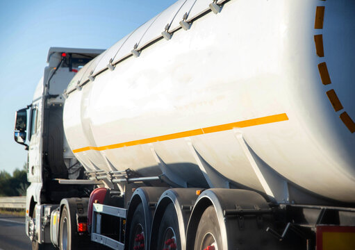 A truck tractor with a tank semi-trailer is transporting a hazardous flammable cargo - fuel. Transportation of diesel fuel in a tank. Cargo hazard class