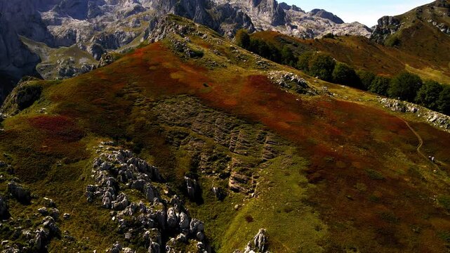 Aerial Tilt Up Forward Beautiful Shot Of Green Mountain Range Against Cloudy Sky - Plav, Montenegro