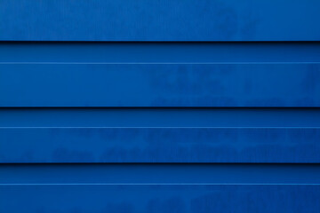 Fototapeta premium Simple, horizontal bands of vibrant, slightly textured blue