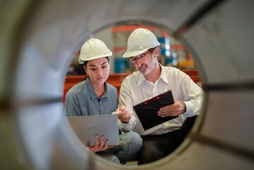 partner woman engineer assistant in helmet inspection check heavy machine construction installation...