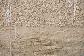 Rough wall with old paint stains.