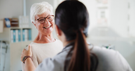 Fototapeta na wymiar Consulting, doctor and happy with old woman in office for patient feedback, insurance and physiotherapy plan. Healthcare, rehabilitation and medical help with people in clinic for support and trust