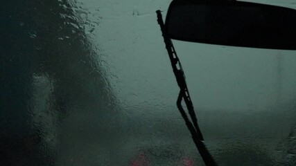 young man driving a car, time lapse of a car driving in the city, rear view of a car,  rain drops on window