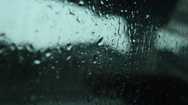 young man driving a car, time lapse of a car driving in the city, rear view of a car,  rain drops on window