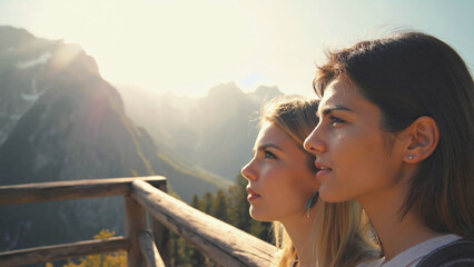 Embracing the Horizon: Two friends stand side-by-side, gazing upon a breathtaking panorama of majestic mountains, a moment of serene reflection amid a vibrant landscape.