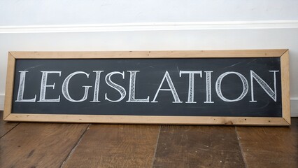 Obraz premium A rustic chalkboard sign displaying LEGISLATION hinting at new laws and political action in a farmhouse style with a