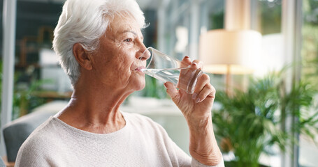 Home, drinking water and old woman in lounge, wellness and hydration with morning routine....