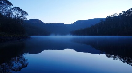 Fototapeta premium Serene Blue Lake Reflection at Dawn