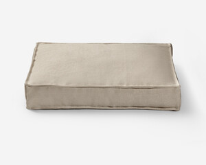 Beige pet bed cushion resting on white background