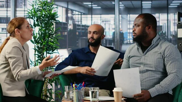 Group argument in a corporate office between diverse professionals, involving negotiation conflict and commitment issues. Business meeting with leadership frustration. Camera B.