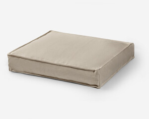 Comfortable pet bed resting on white surface in bright studio