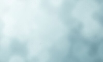 Soft, blurred background with gentle tones of light blue and gray.