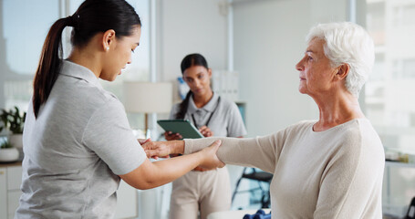 Fototapeta premium Physiotherapy, consulting and healthcare with old woman and doctor for rehabilitation, osteoporosis or medical. Physical therapy, help and advice with people in clinic for healing and orthopedic exam