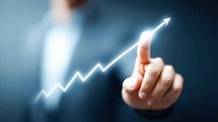 A person's finger pointing to a glowing upward trend line, symbolizing growth and success. Focus on business.
