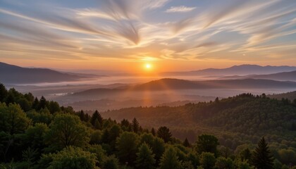 Breathtaking Sunrise Over a Misty Valley Surrounded by Lush Green Forests and Mountains