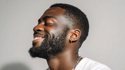Obraz premium Young Man Laughing with Closed Eyes in Profile View