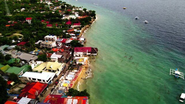 Aerial Forward Beautiful Shot Of Houses By Wavy Sea Coastline - Moalboal, Philippines