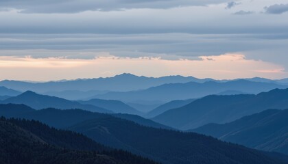 Obraz premium Majestic Mountain Range Under Soft Clouds at Dusk with a Beautiful Horizon View