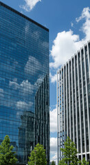 Skyscrapers & Sky: Architectural Reflections in Modern City Buildings under Blue Sky with Clouds. Urban Landscape & Design