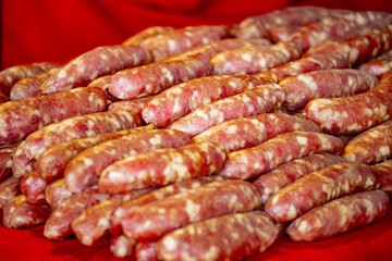 a pile of fresh raw sausages stacked together
