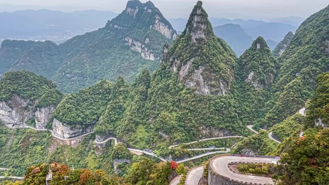View landscape range mountain and road 99 curve turn for chinese people travelers travel visit Tianmen Shan cave or Heaven Gate in Tianmen Mountain National Forest Park at Zhangjiajie in Hunan China