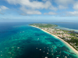 Turquoise sea water with boats and powdery white sand beach in Boracay. Island in Malay, Aklan....