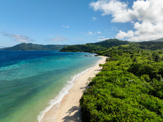 Fototapeta premium Drone view of Bon Bon Beach with turquoise sea waves on sandy beach. Romblon Island. Romblon, Philippines.