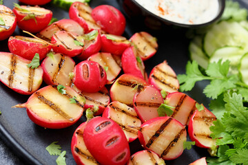 grilled radishes with cucumber slices and sauce