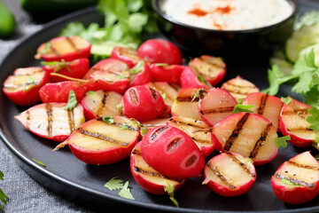 grilled radishes with cucumber slices and sauce