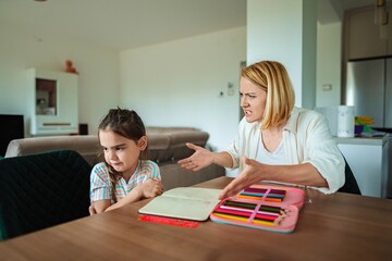 Mom and daughter share a tense moment in the kitchen