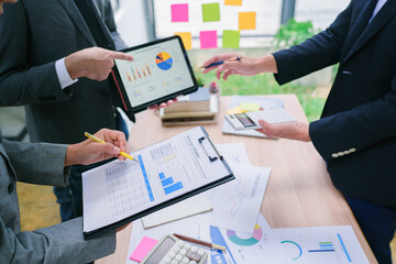 Cropped photo of business people sitting at the desk on workplace in office shaking hands with a colleague reaching agreement making a good deal or signing a contract. Business people at work.