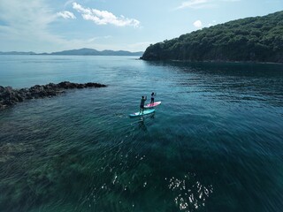 Aerial view A phinisi boat is sailing carrying tourists who will visit the islands around the waters of Labuan Bajo, East Nusa Tenggara, Indonesia.
