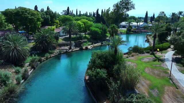 Aerial: Scenic View Of Kibbutz Community Landscape, Drone Flying Forward Over Asi River Stream - Nir David, Israel
