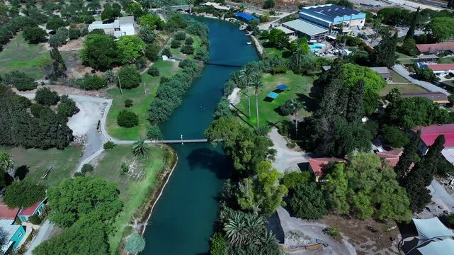 Aerial Shot Of Residential Houses On Residential Landscape, Drone Flying Forward Over Asi River Stream During Sunny Day - Nir David, Israel