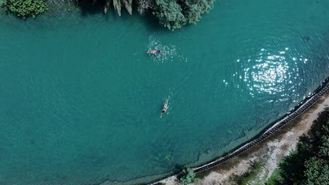 Aerial Top Upward Shot Of Women Swimming In Asi River On Sunny Day - Nir David, Israel