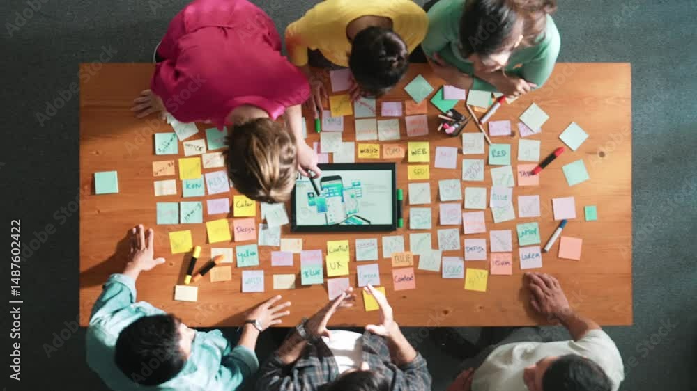 Poster aerial view of developer team discussing and showing digital program and writing by using ux ui desi