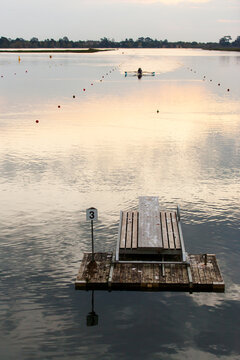 Rowers training on a lake in the evening