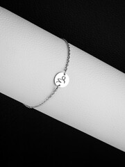 close up silver bracelet horoscope with Capricorn  sign on white background