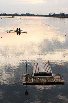 Rowers training on a lake in the evening